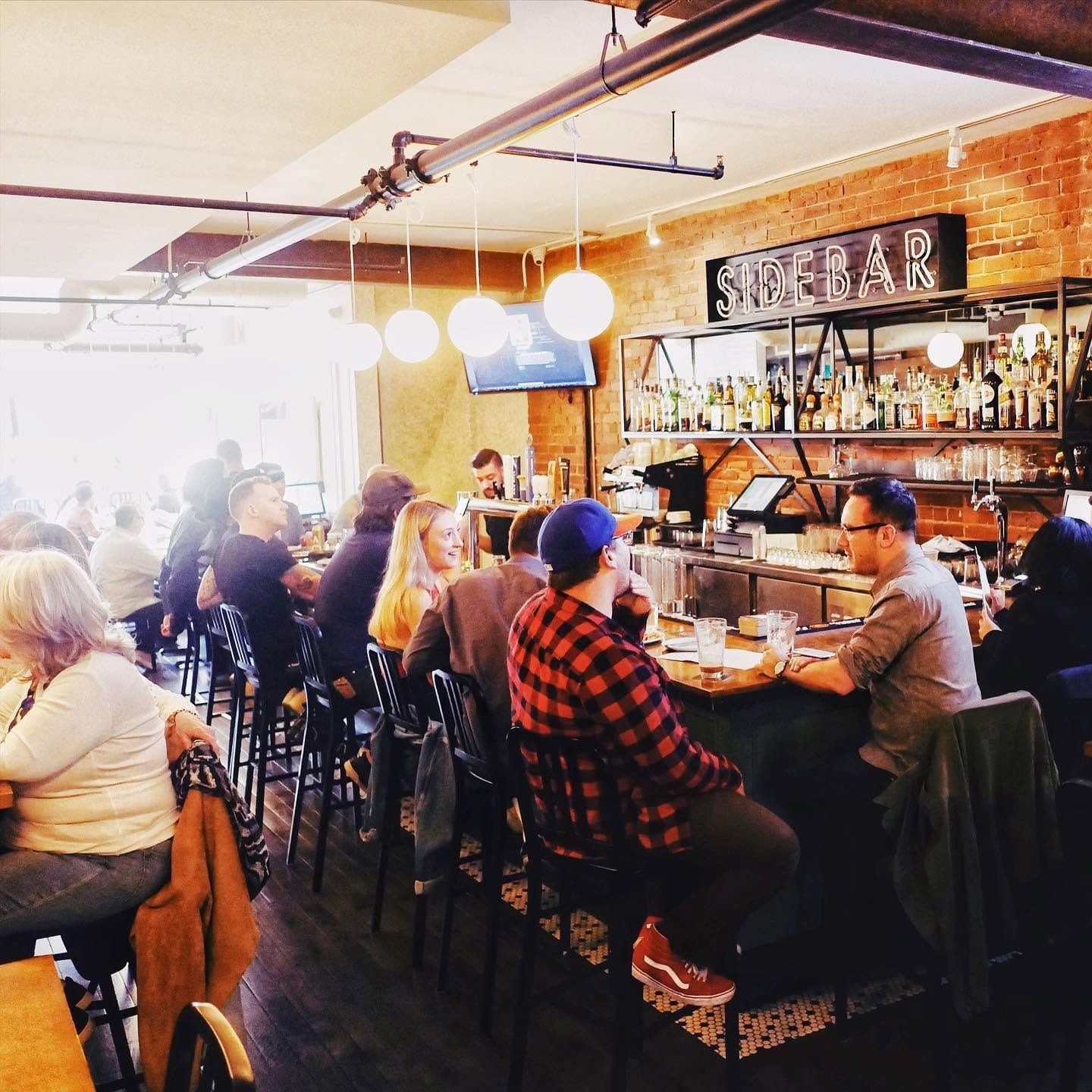 A full bar on a busy night, with guests on every stool